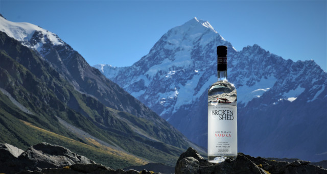 A bottle of Broken Shed with mountains in the background